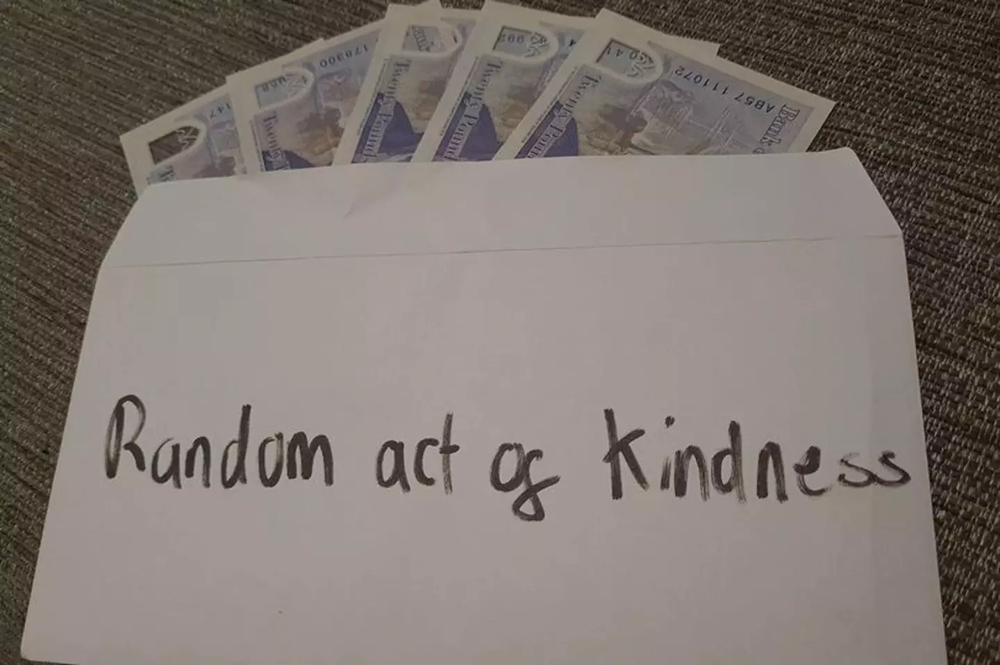 Some mystery merry-maker is going around posting envelopes filled with £100 in a 'random act of kindness'.