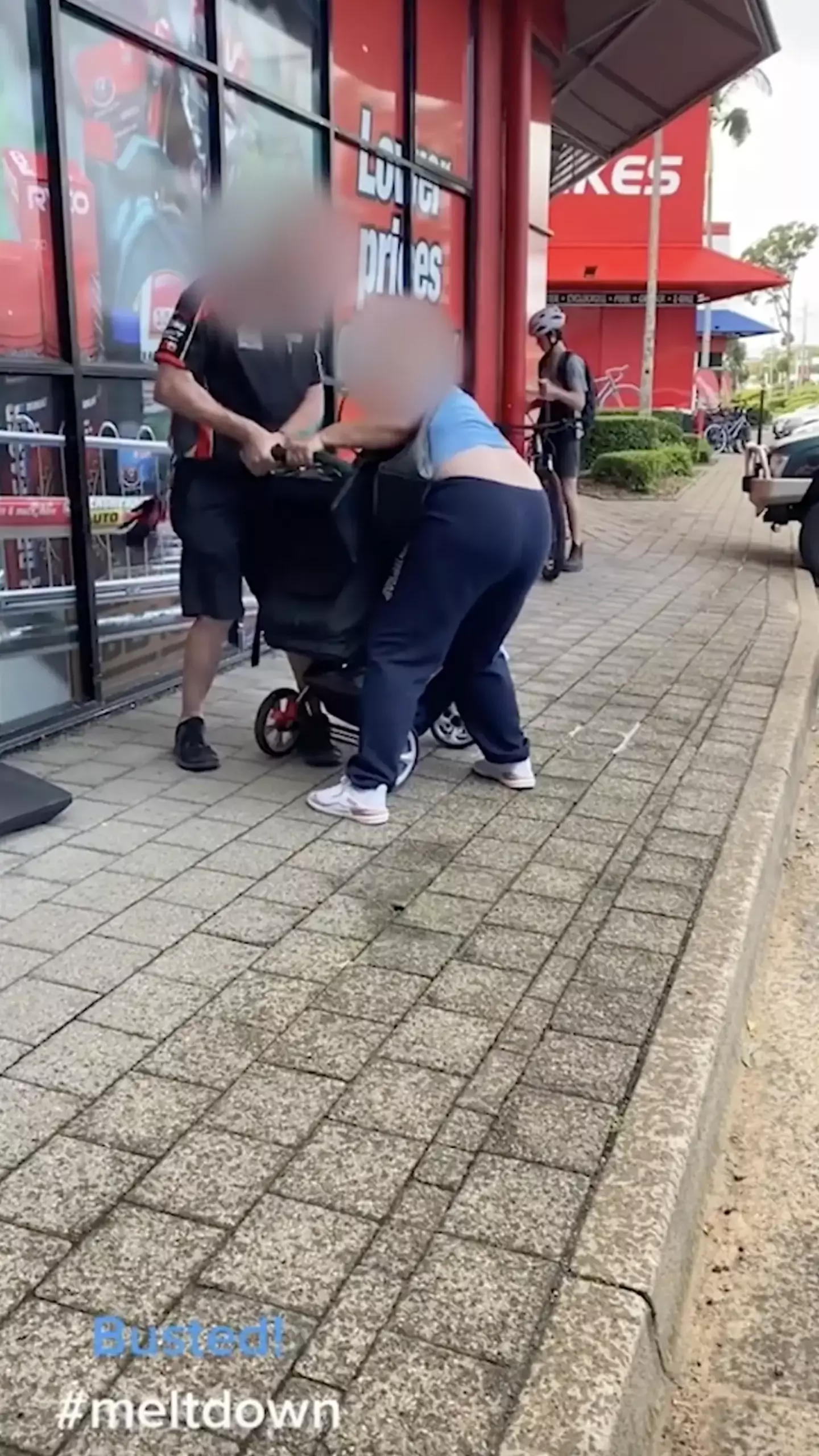 The employee was filmed confronting a 'thief' who had loaded up a pram with stolen goods.