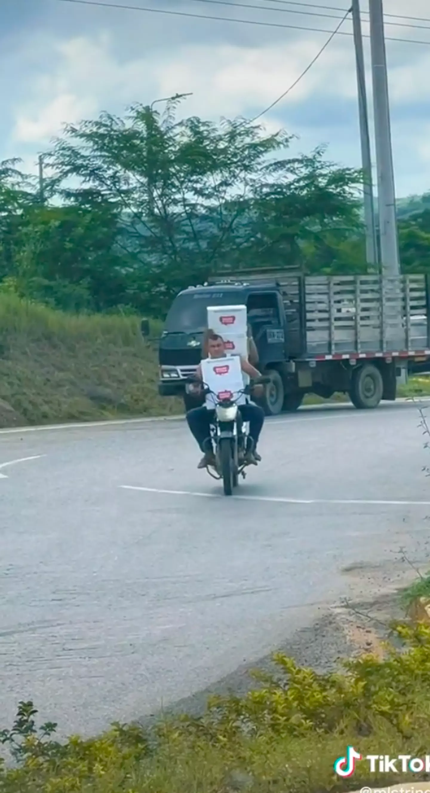 People in Colombia wasted no time scurrying over to an overturned truck to grab armfuls of Stella bottles.
