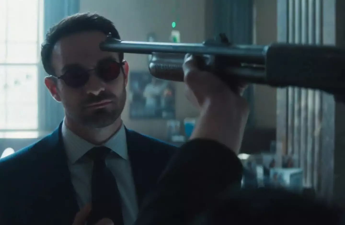 Our hero seems unconcerned that someone is pointing a gun at him. (Disney)