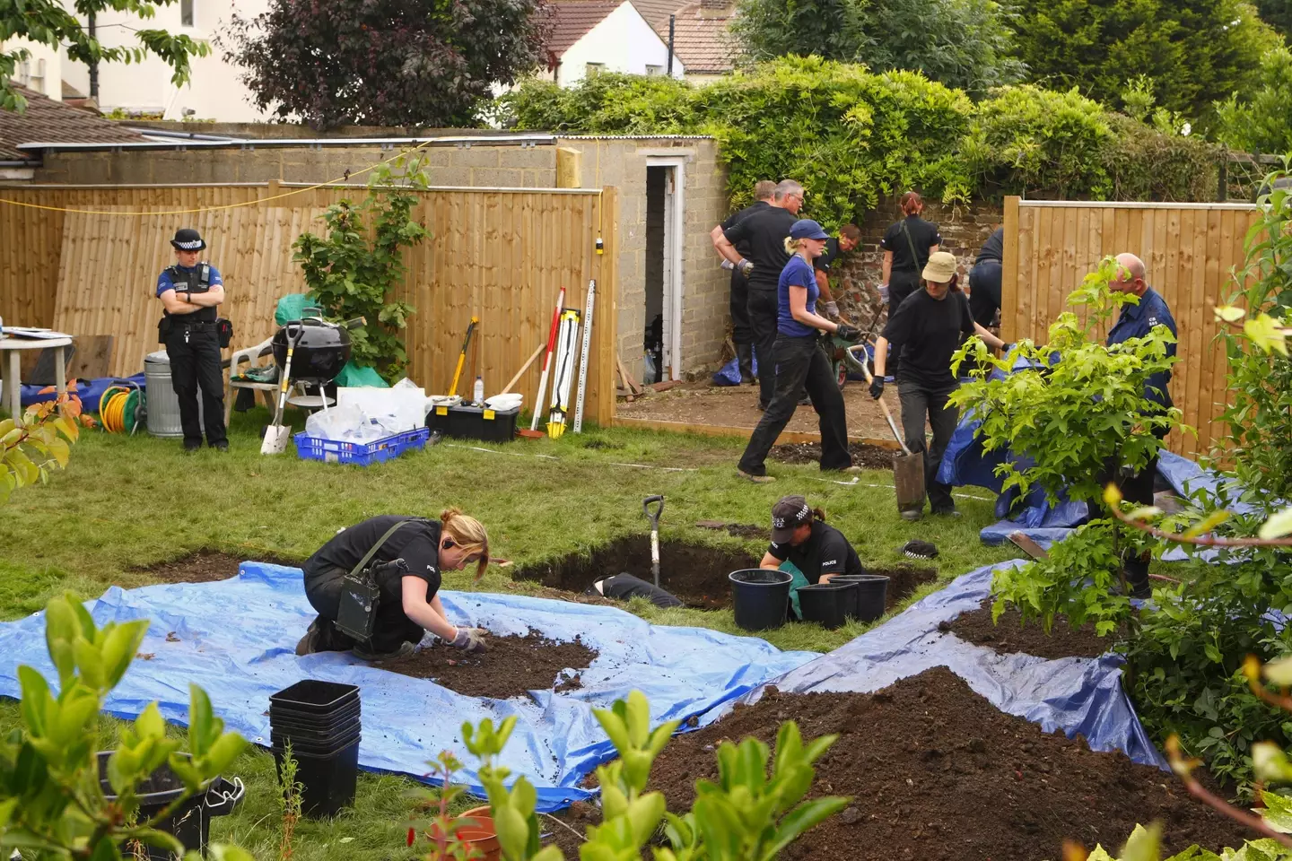 Officers from Sussex Police search the garden of a house in Station Road, Portslade, where Peter Tobin also once lived.