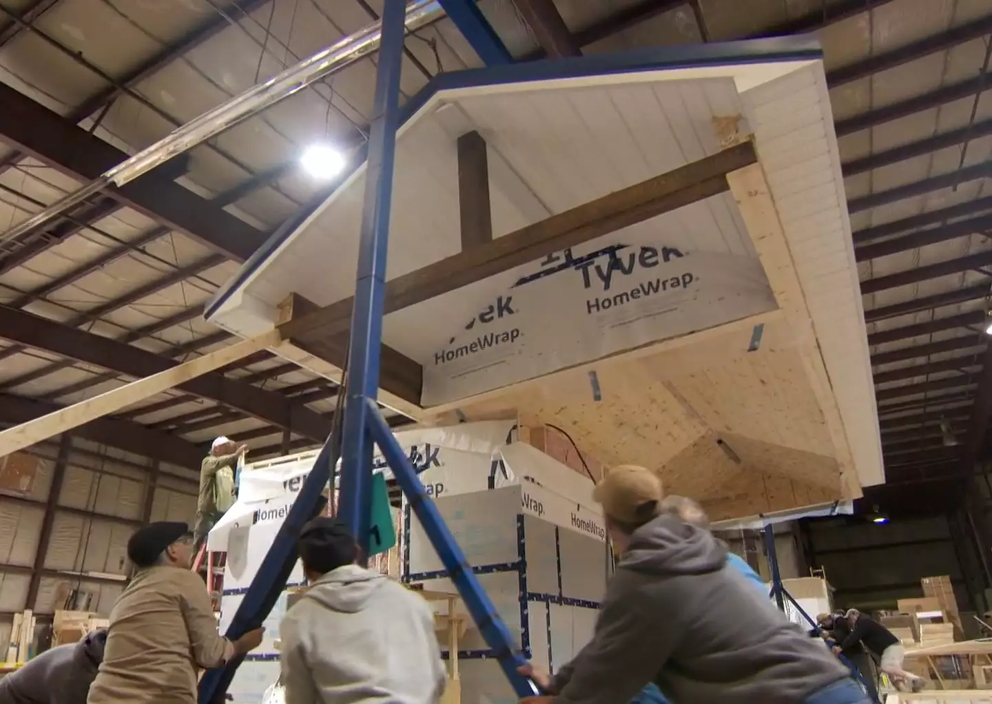 Each 'tiny house' is constructed in a warehouse before being loaded onto concrete blocks.