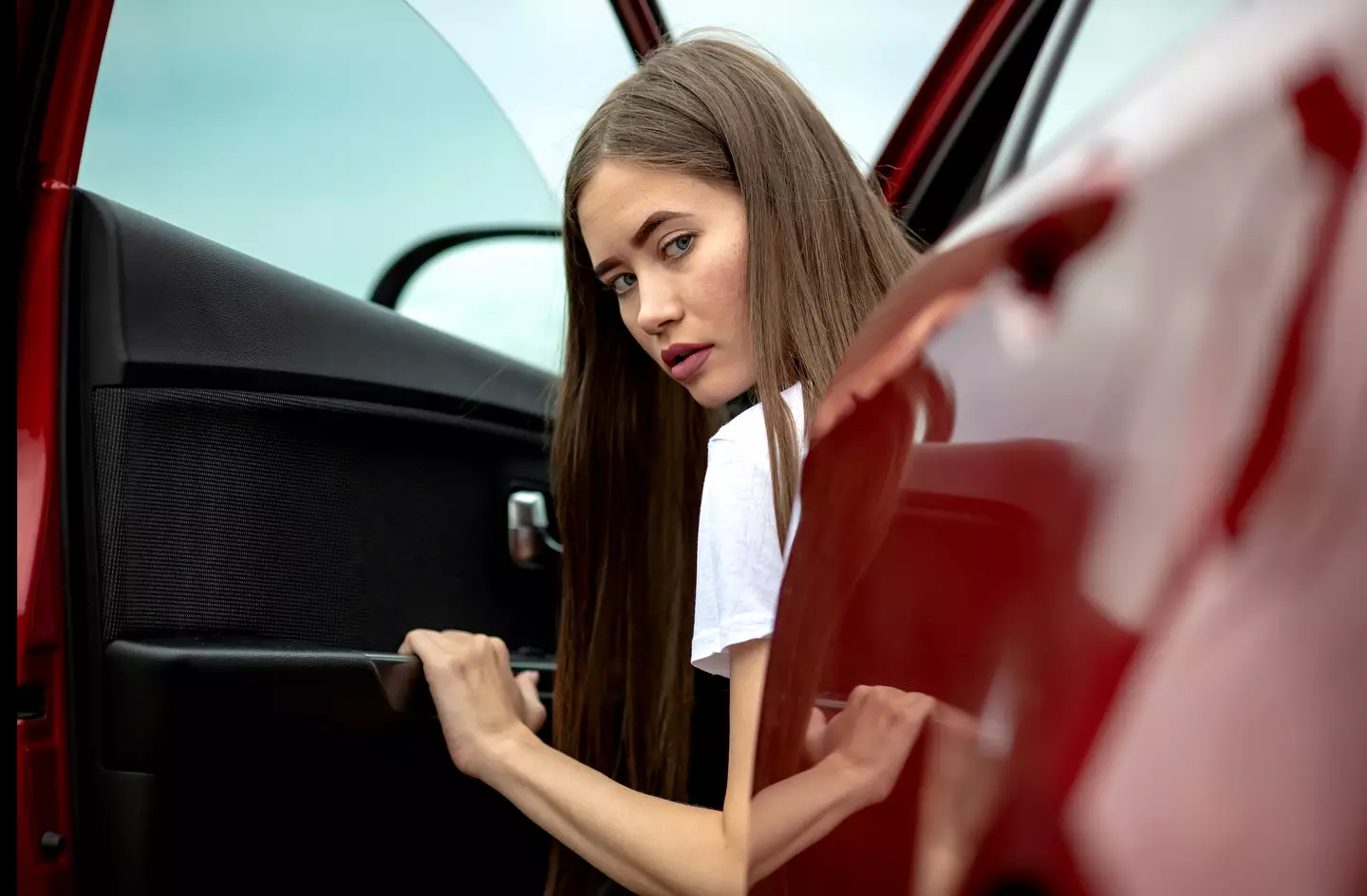 Woman with door open looking at reverse parking
