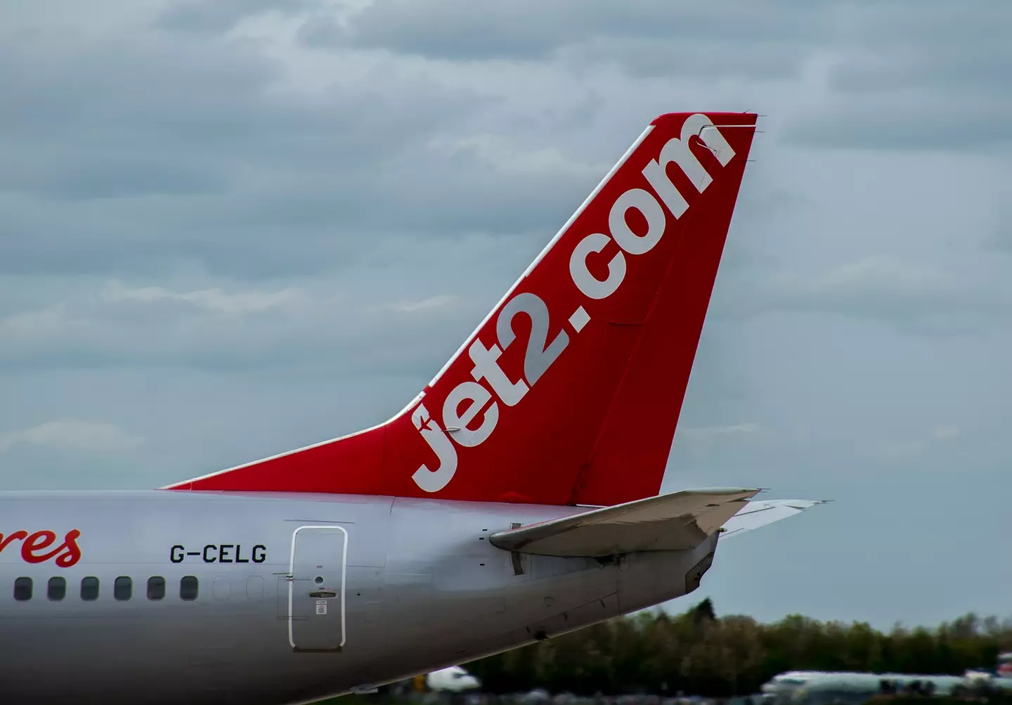 A dad restrained a woman who stripped nude and tried to storm the cockpit during a Jet2 flight.
