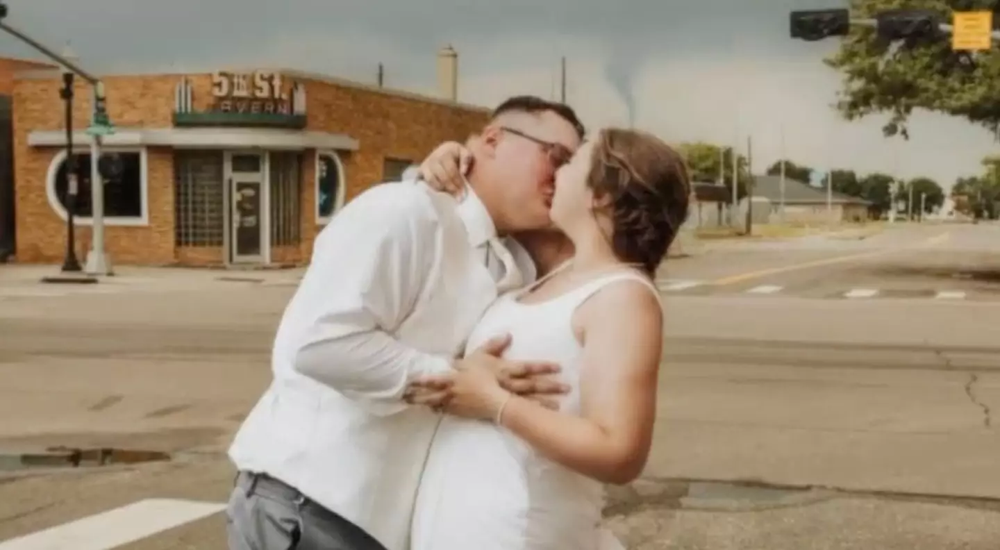 People spot terrifying detail as newlywed couple kiss for wedding day photo 2 Austin and Hailey Bode had an unlikely photobomber in the back of their wedding snaps. (1011Now/Wallace and Sage)