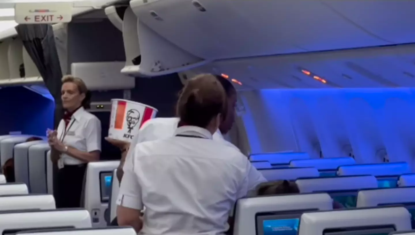 British Airways staff were caught on camera handing out food from the KFC buckets.