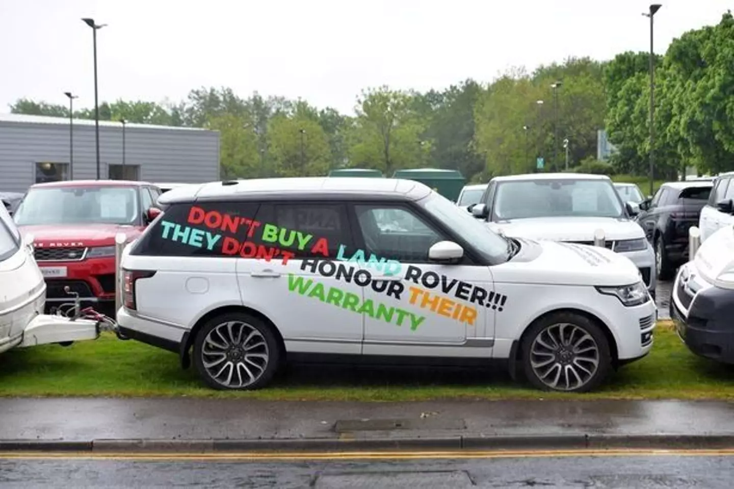 The vehicles are right outside the Land Rover dealership.