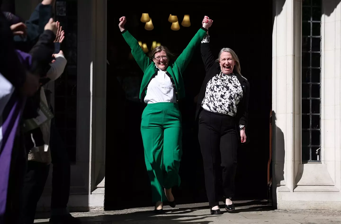 The For Women Scotland directors celebrate at the Supreme Court as others fear for trans rights in the UK. (HENRY NICHOLLS/AFP via Getty Images)