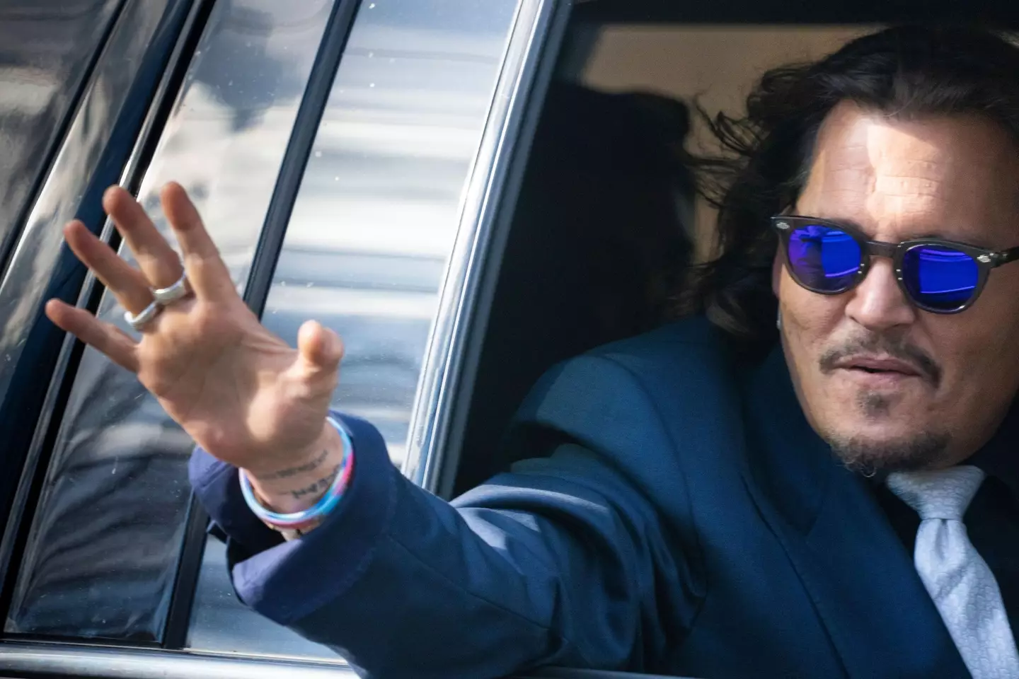 Johnny Depp waving at onlookers in Virginia.