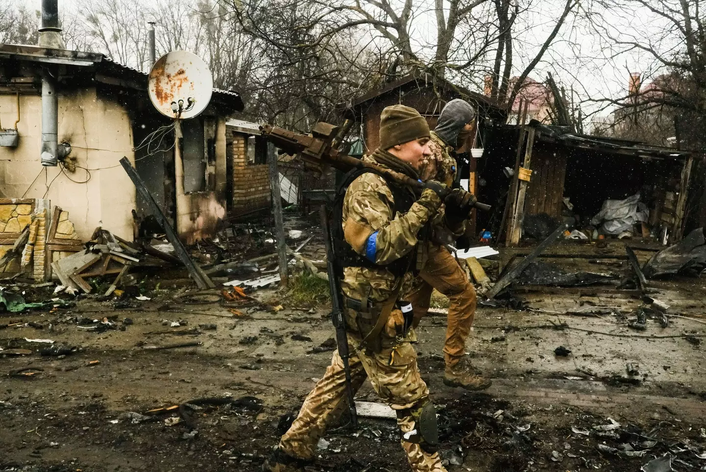 Ukrainian soldiers inspecting the decimated town of Bucha.