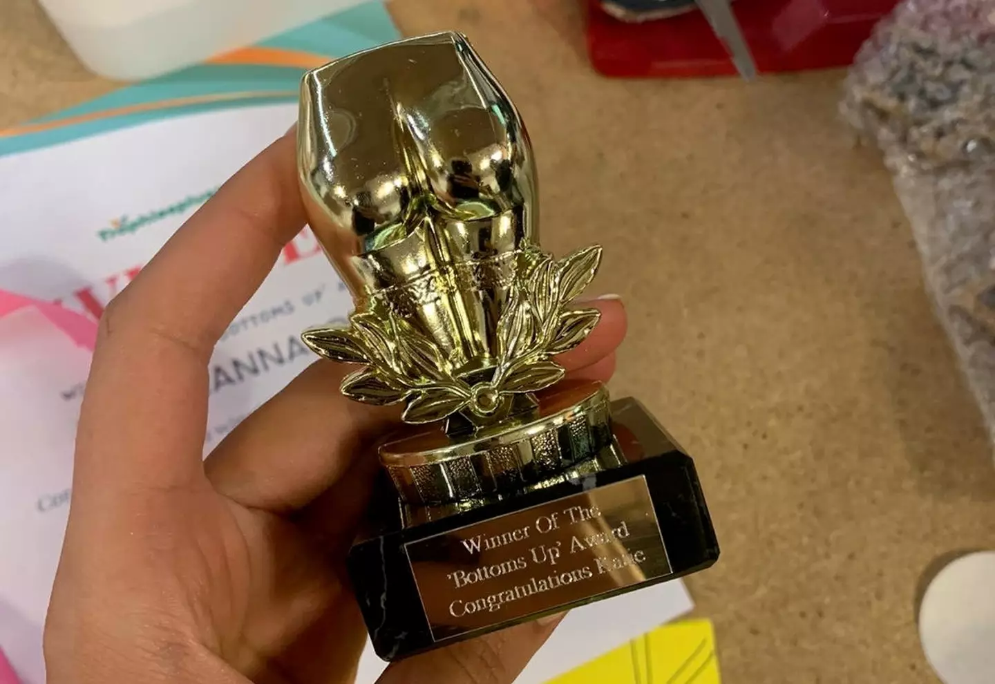 The trophy is shaped like Katie’s bottom.
