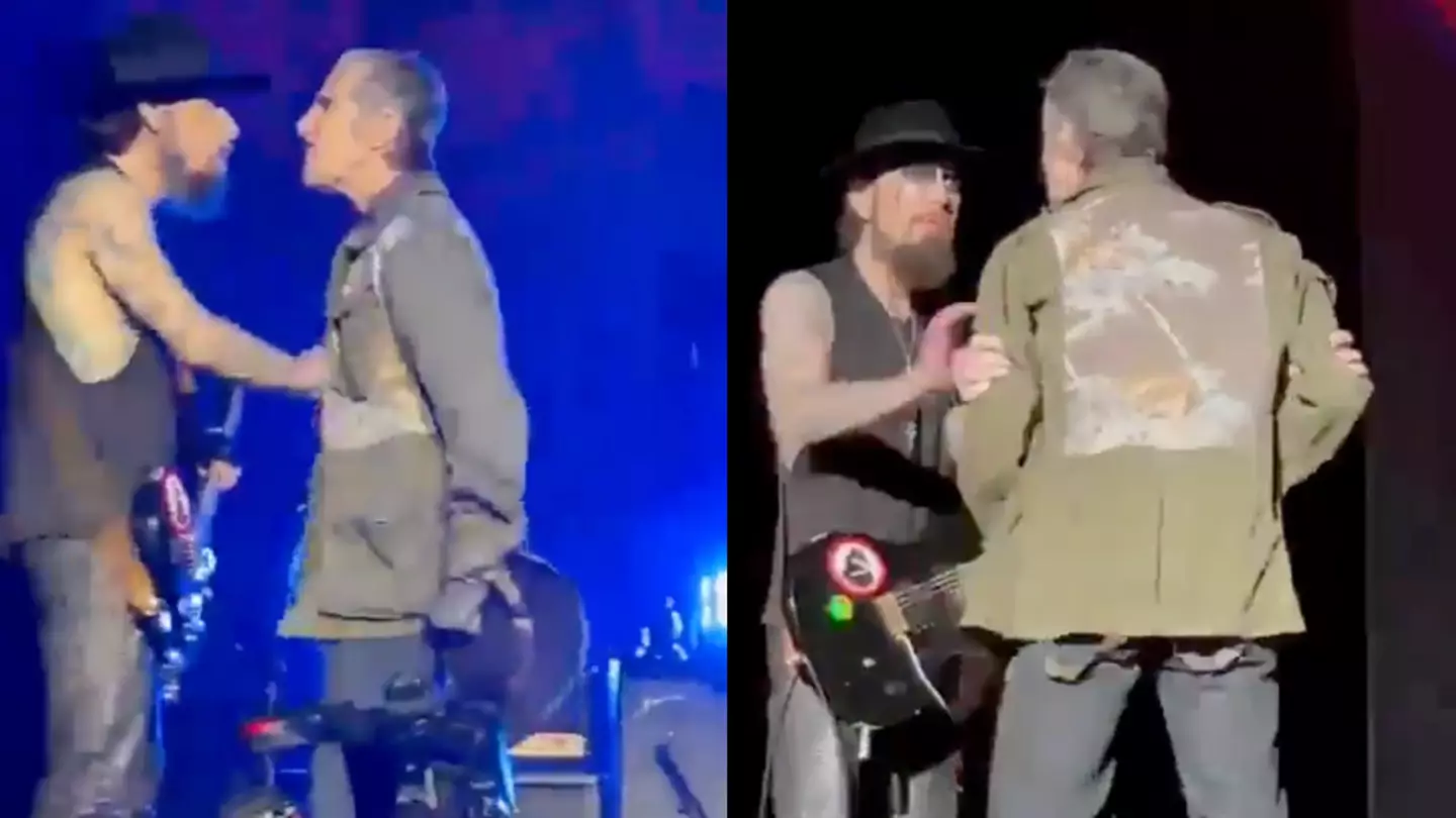 Wife of iconic band's singer who punched guitarist in shocking onstage moment explains why he did it