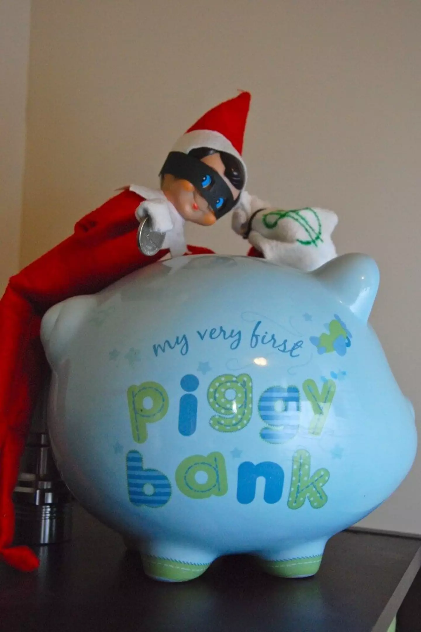 Elf robbing the piggy bank. (