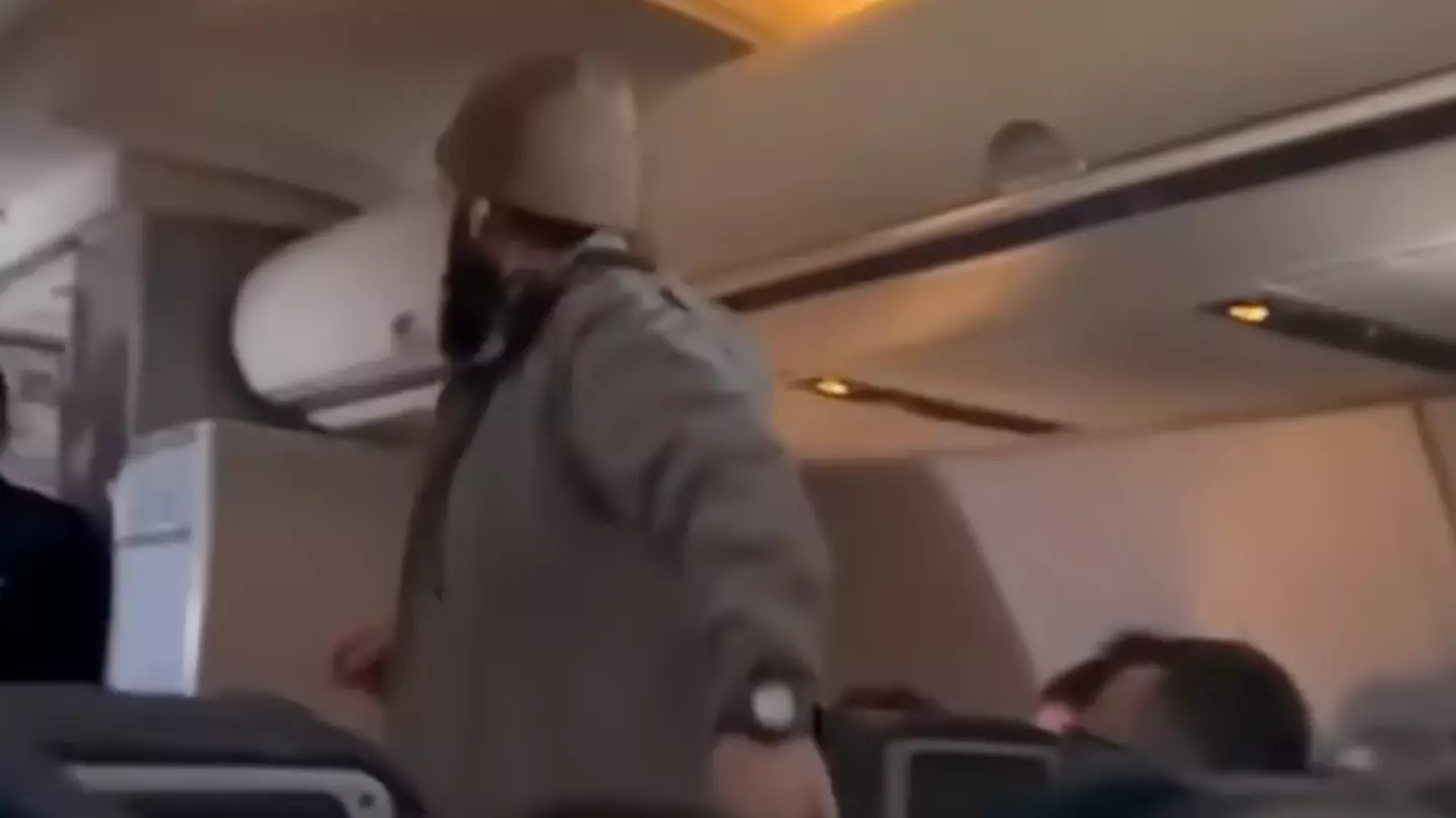 Horrifying moment passenger tries to stab flight attendant mid air while trying to open emergency exit