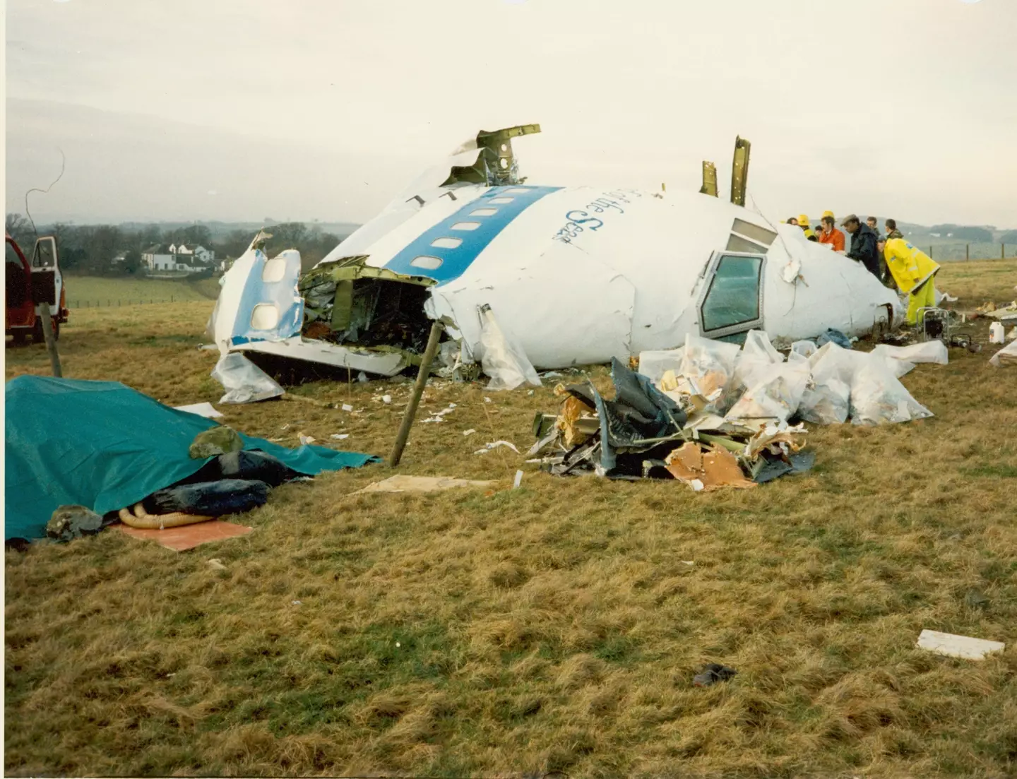 A crane lifting part of the destroyed aircraft.