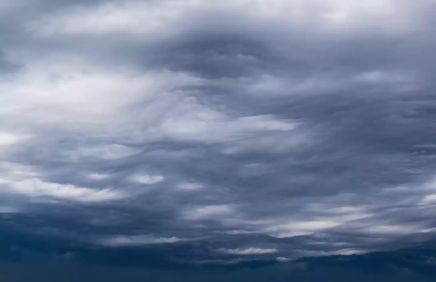 The clouds move like waves in the sky.