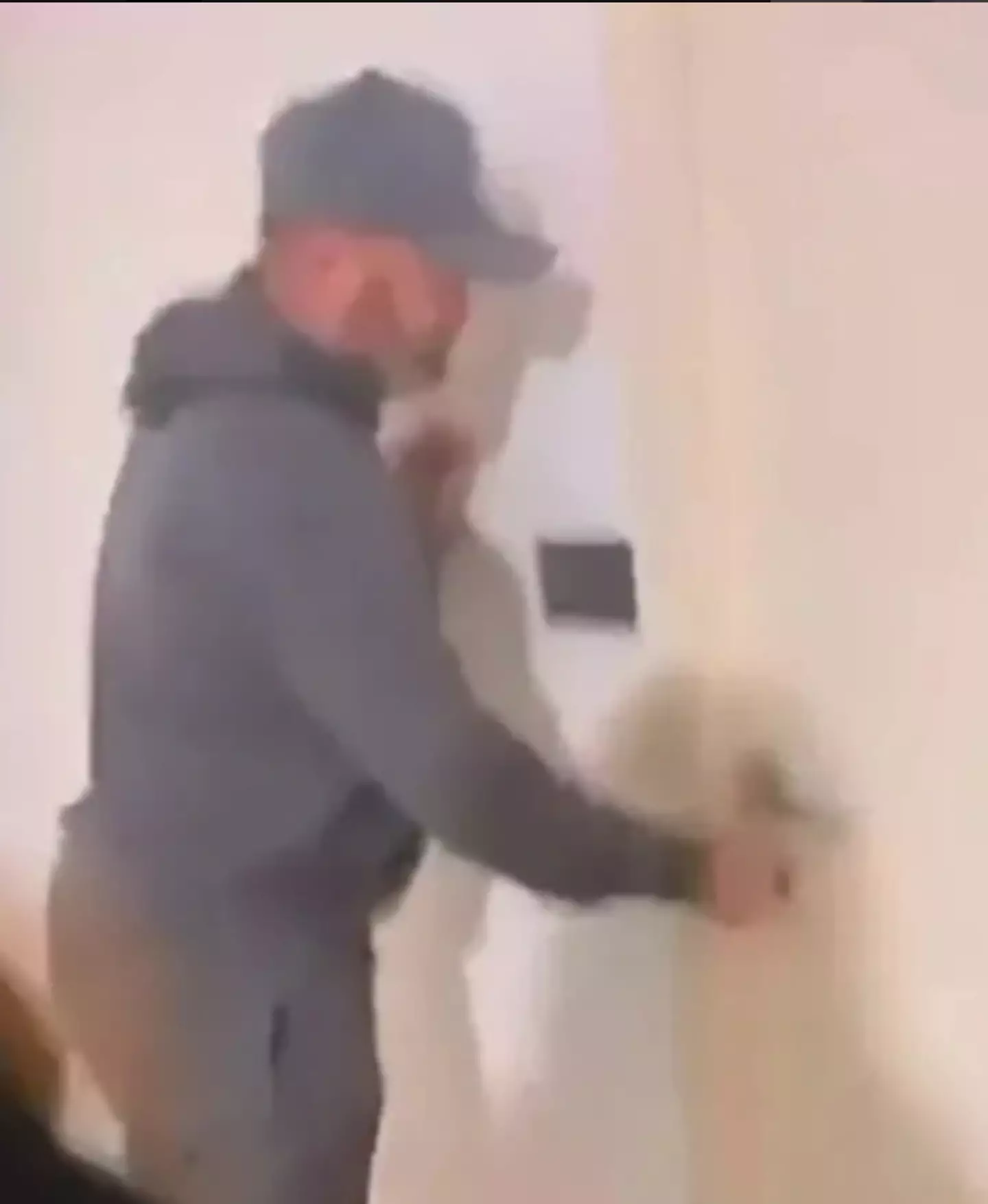The viral clip shows him opening his flat while a woman waits behind. (X)