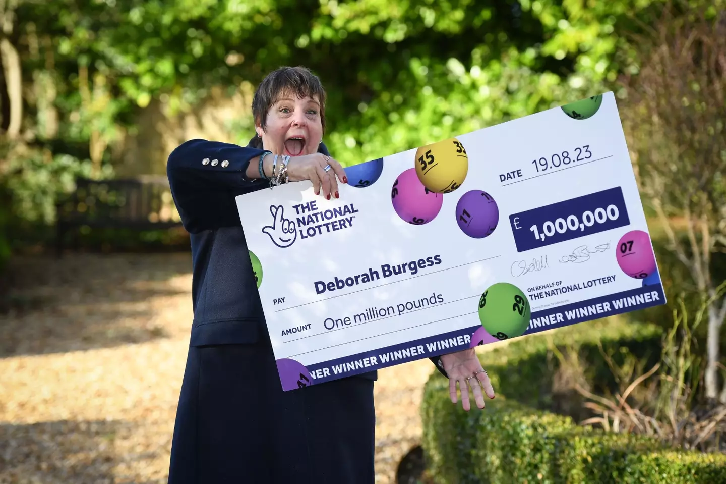 Deborah Burgess finally celebrating with her big cheque.