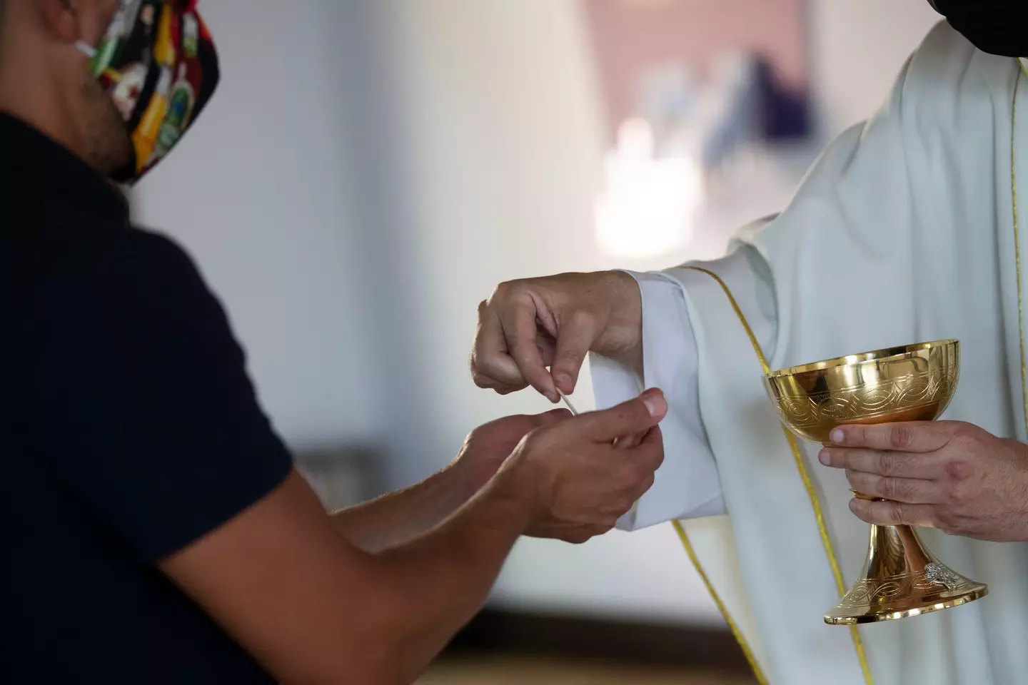 Father Andres Arango distributing communion at St. Gregory's Catholic Church in May 2020.