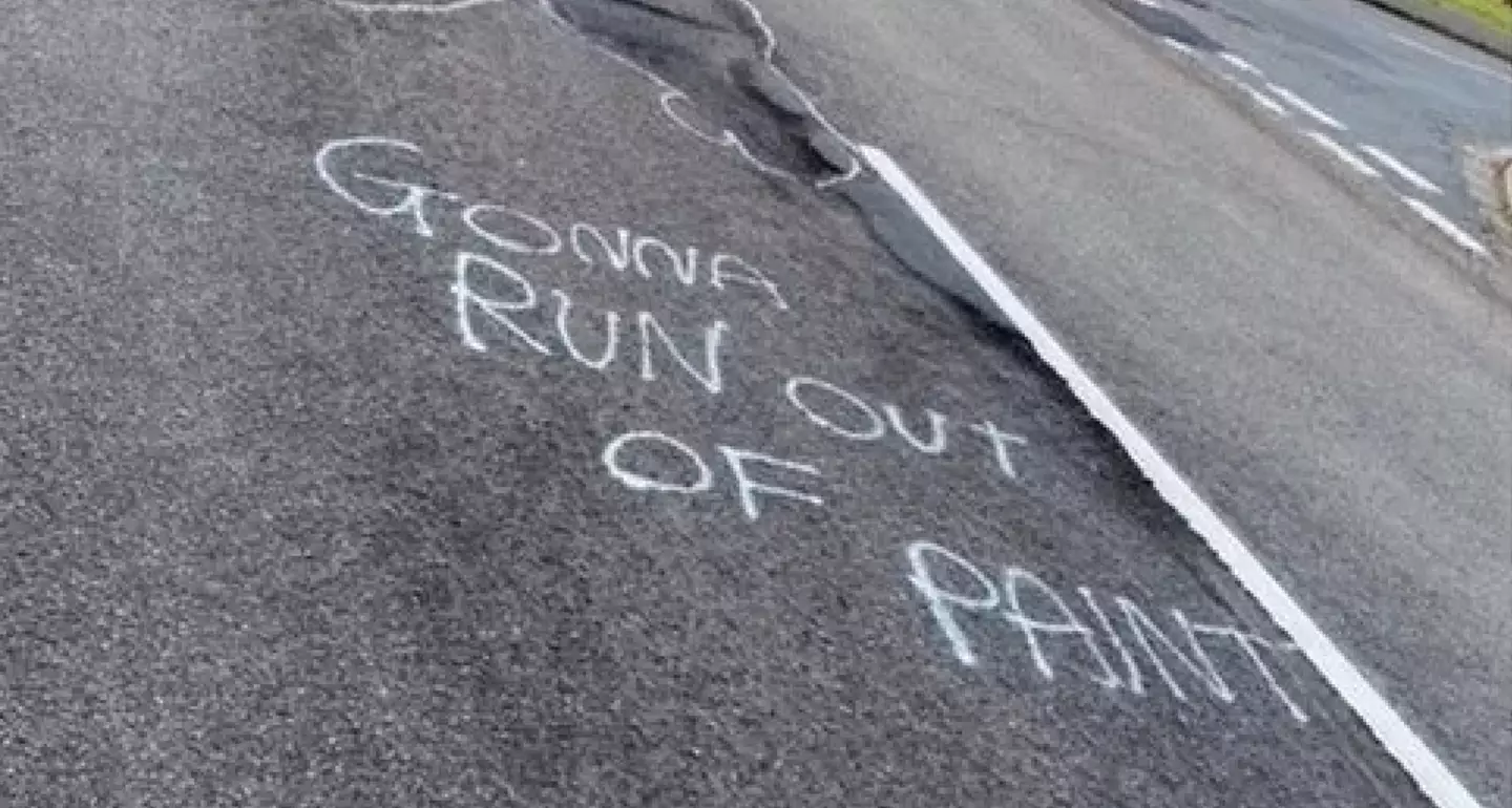 The mysterious graffiti artist painted over the potholes on the street.