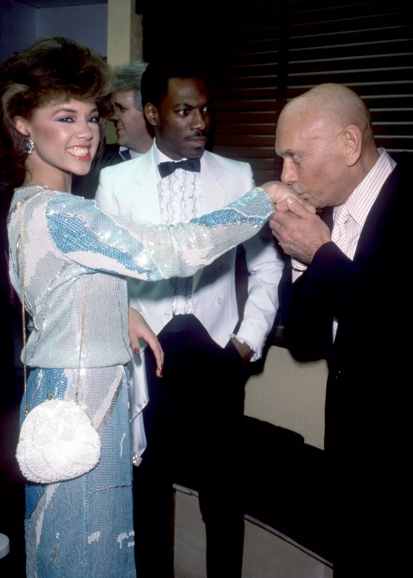 Murphy seen gasping as Yul Brynner kissed the hand of American singer and Miss America Vanessa L. Williams in 1984 (Oscar Abolafia/TPLP/Getty Images)