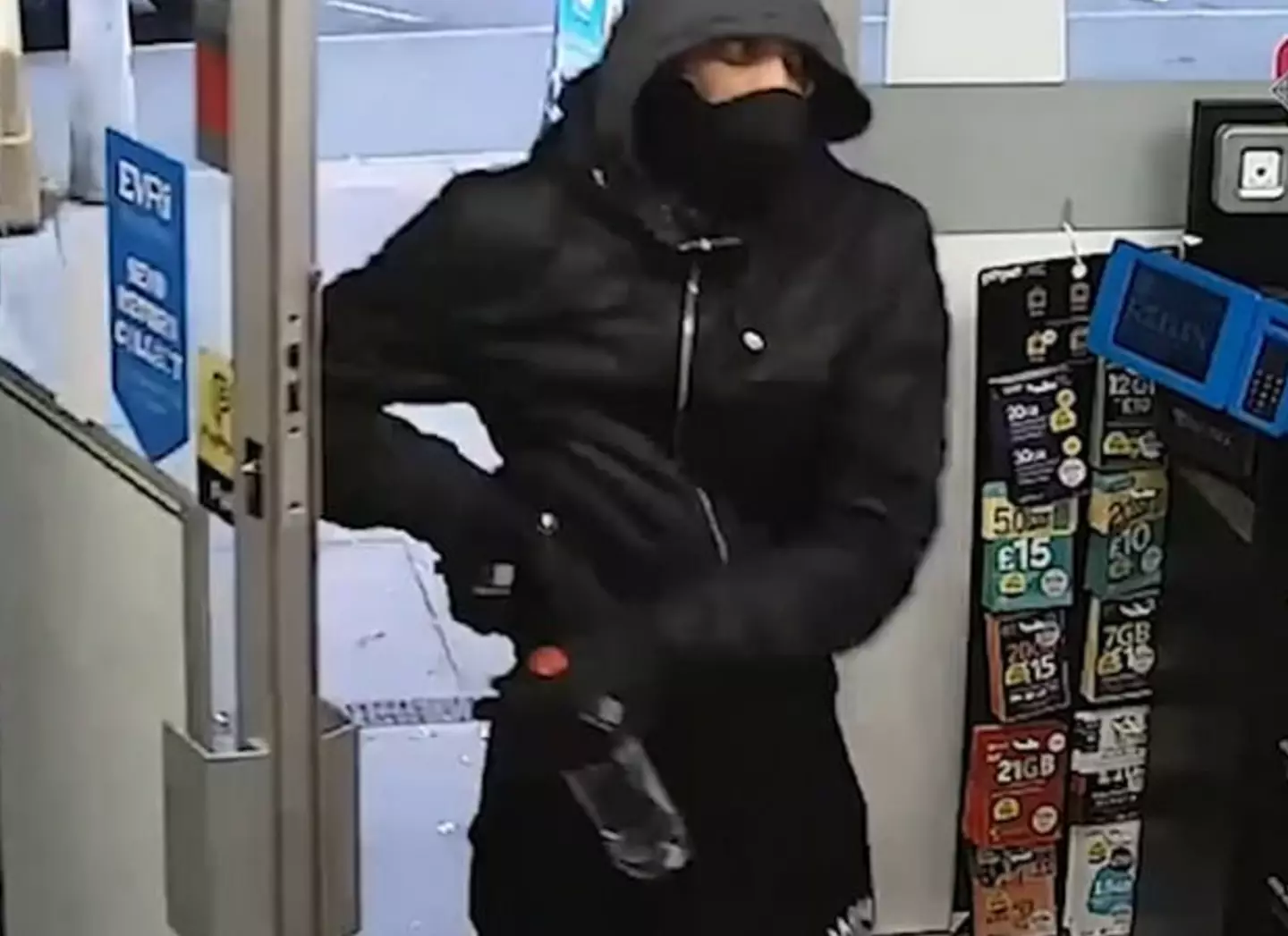 A shop worker is being hailed as a hero after courageously tackling gun-wielding robber.