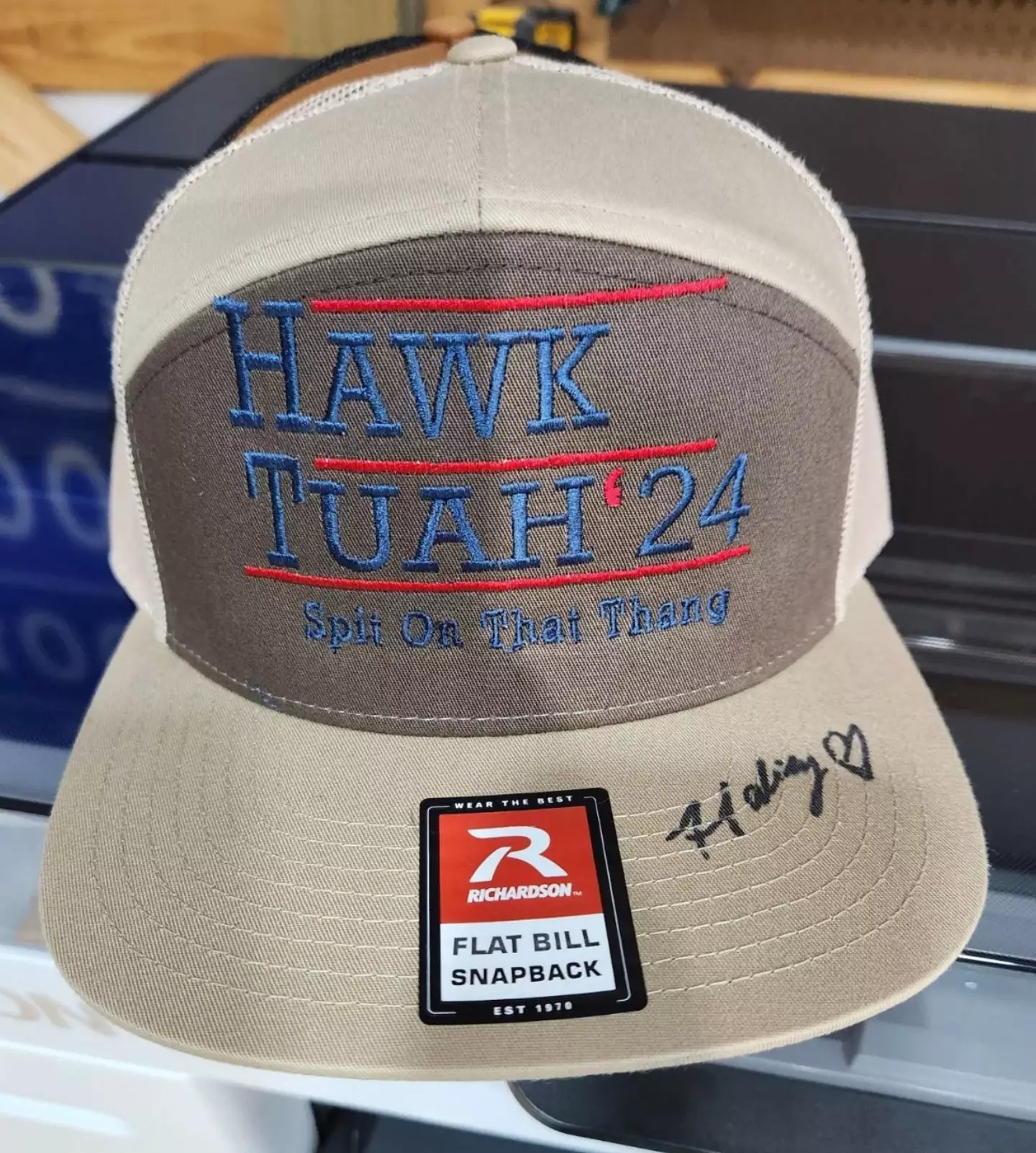 She's selling merch with her famous slogan on, with a signed hat setting you back $50 (Fathead Threads)