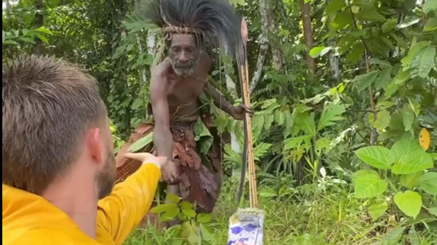 Moment TikToker flees 'cannibal tribe' after offering them a gift that is rejected