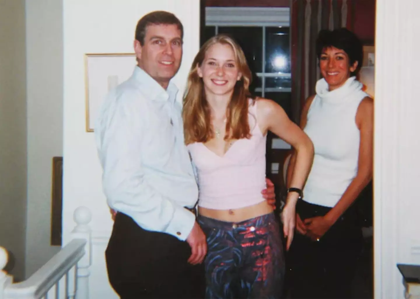 Prince Andrew and Virginia Giuffre, with Ghislaine Maxwell in the background.