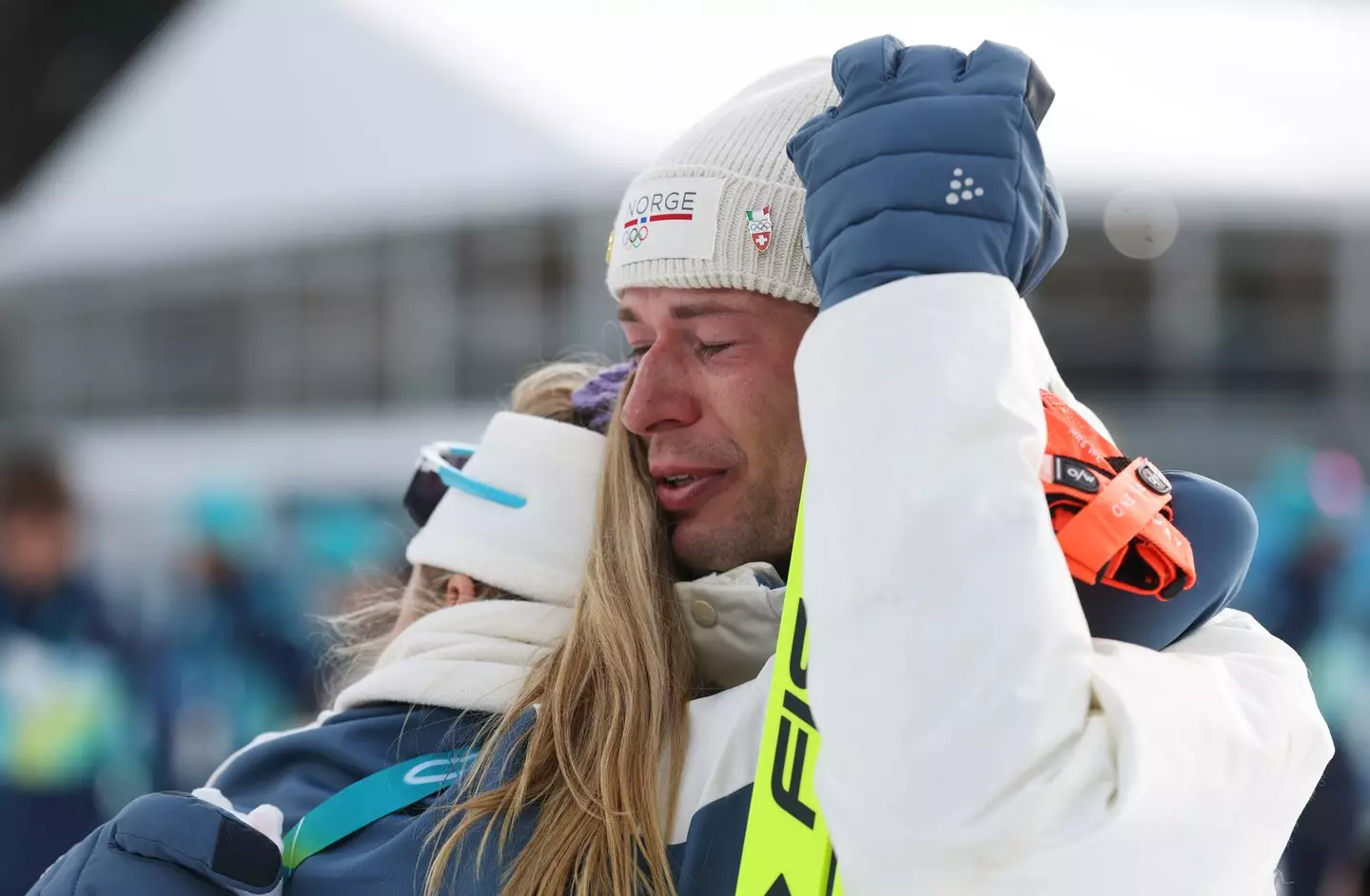 The emotional biathlete seen being comforted by teammate Ingrid Landmark Tandrevold (Alexander Hassenstein/Getty Images)