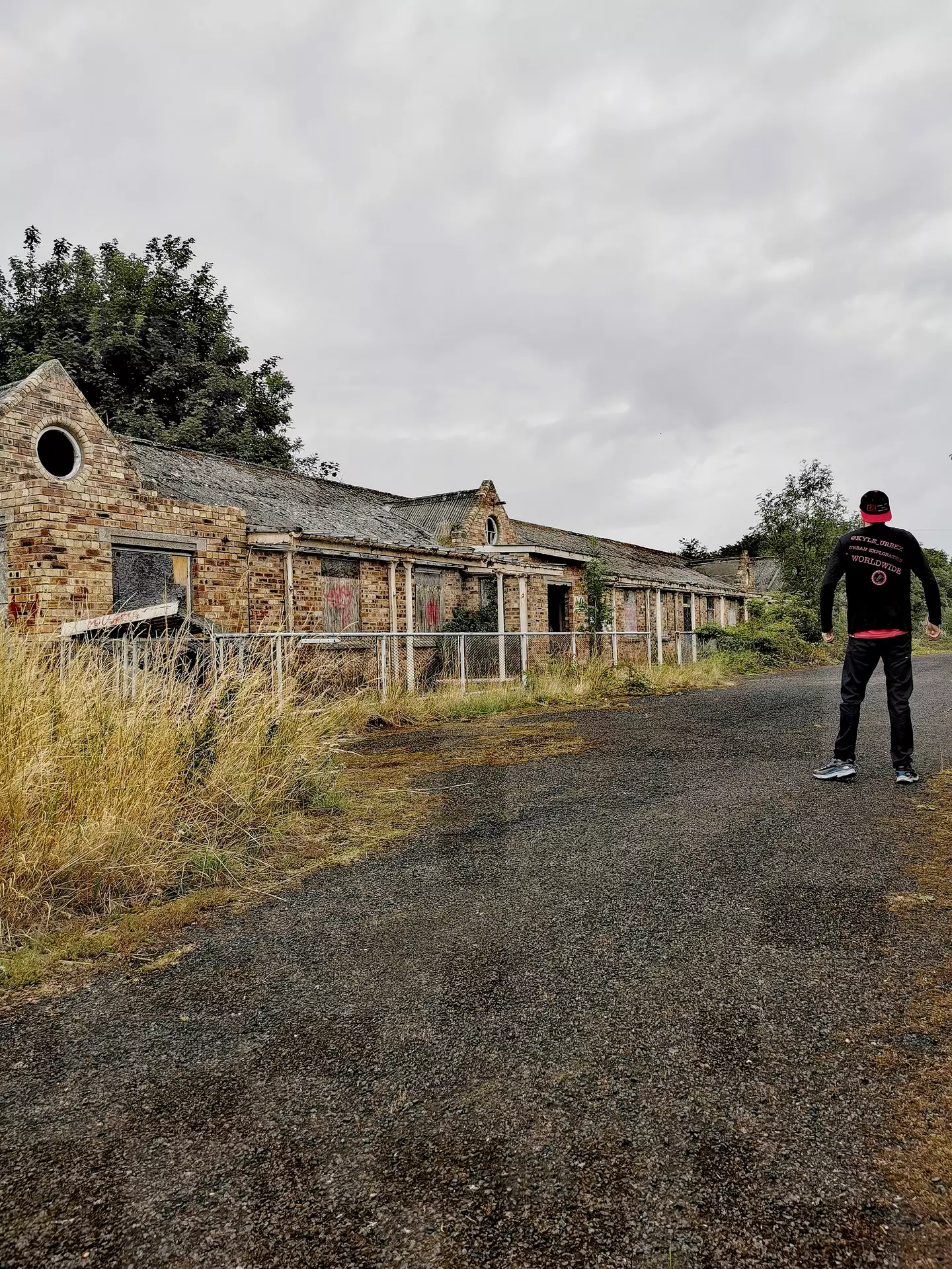 Kyle standing outside the abandoned hospital.