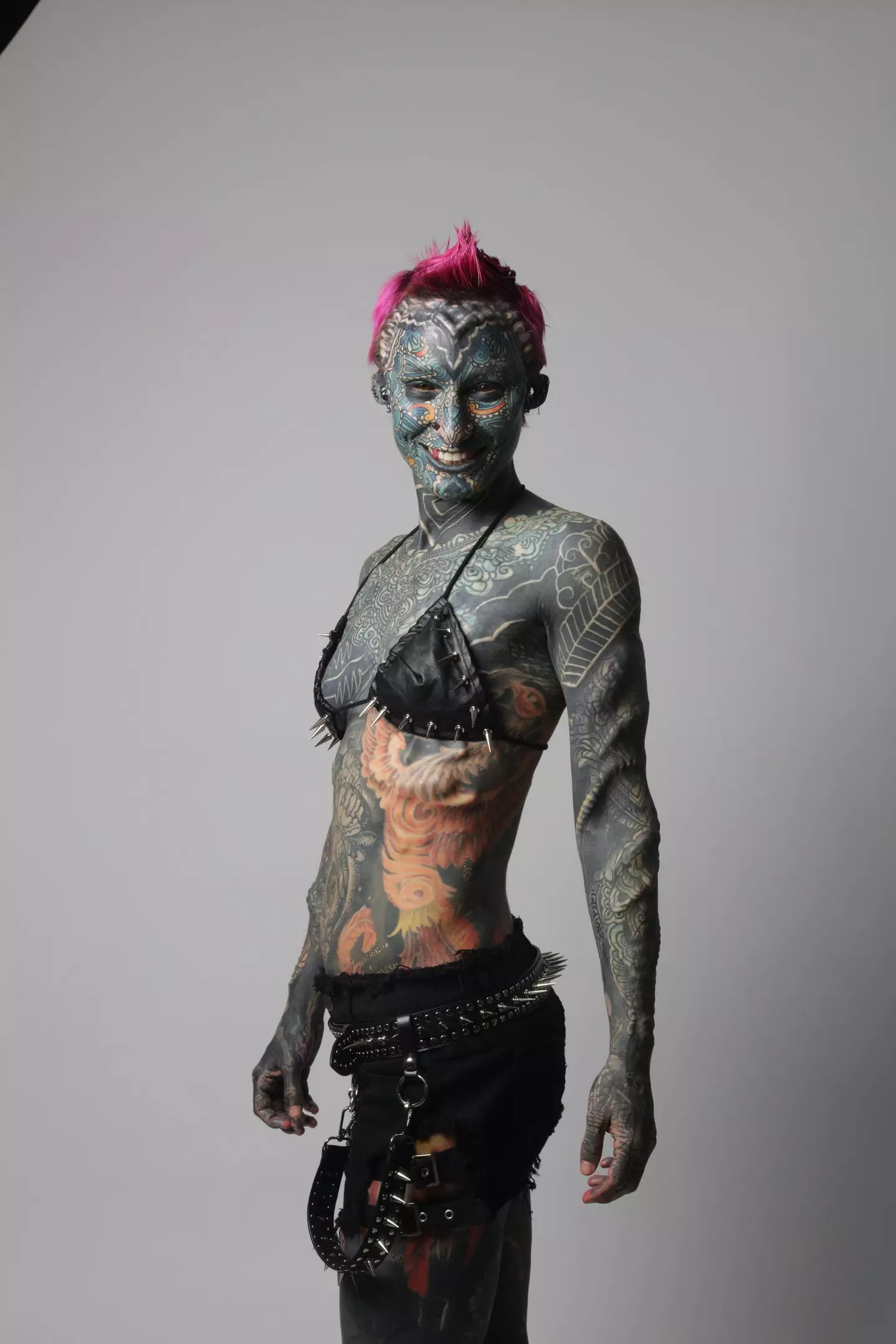 The former medical service officer, 36, has 99.8% of her skin covered in ink as well as 89 body modifications (SWNS)