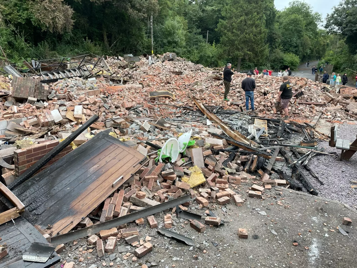 The well-known 18th-century pub in Himley, Dudley, was extensively damaged by a fire on Saturday evening (5 August) before footage emerged on social media of what remained of the building being demolished by a mechanical digger.