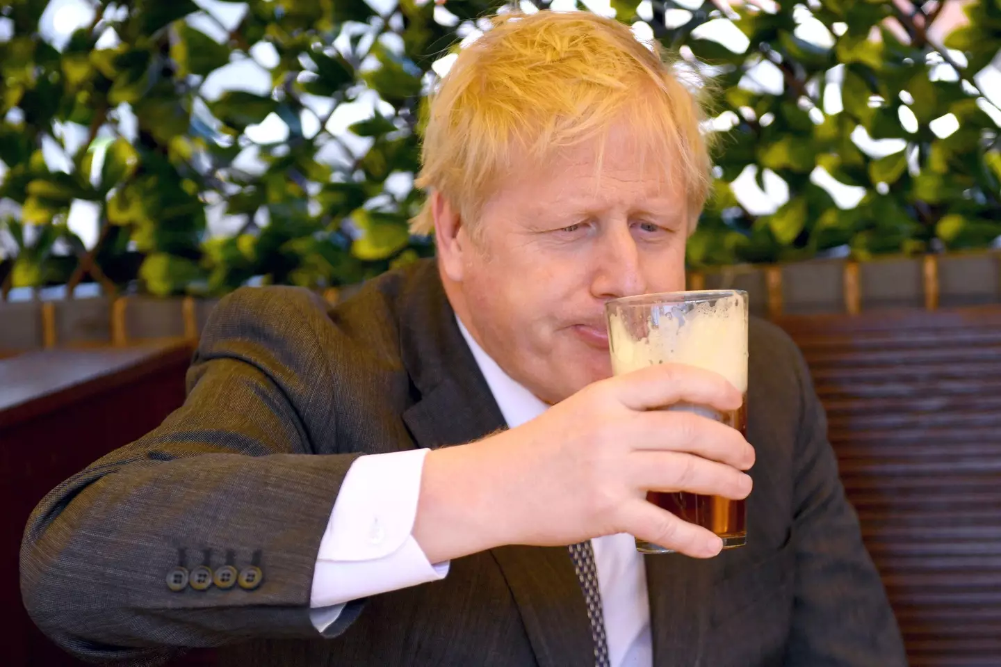 Boris Johnson drinking a pint.