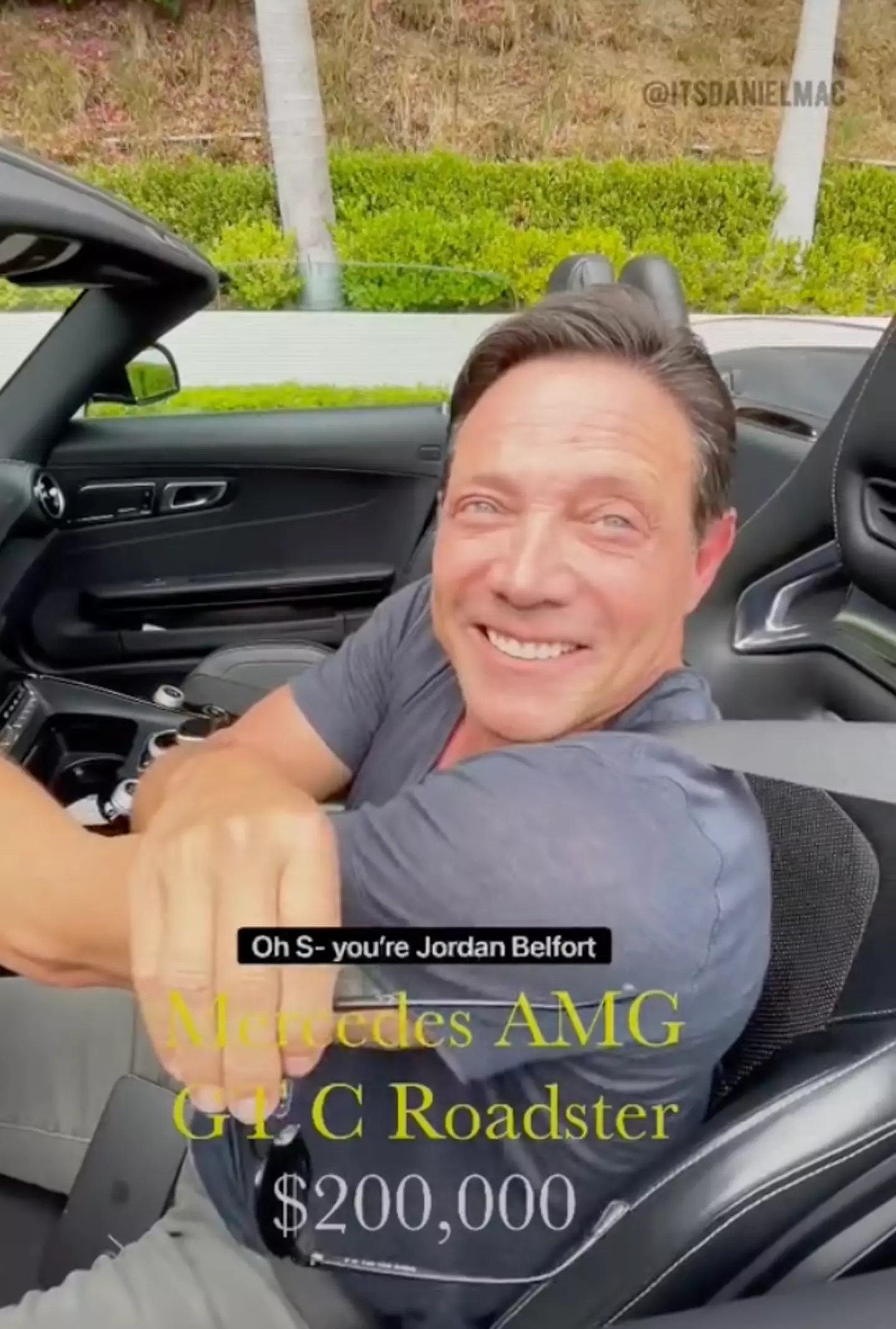 In the clip, Mac heads over to Belfort, who is sitting in his Mercedes-AMG GT C Roadster.