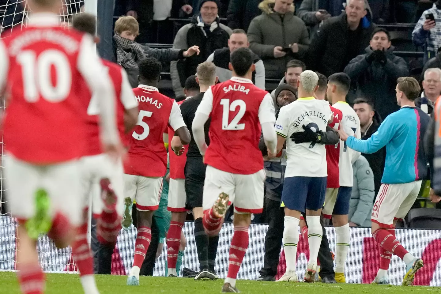 The spectator (top left) aimed a kick at Arsenal's Aaron Ramsdale.