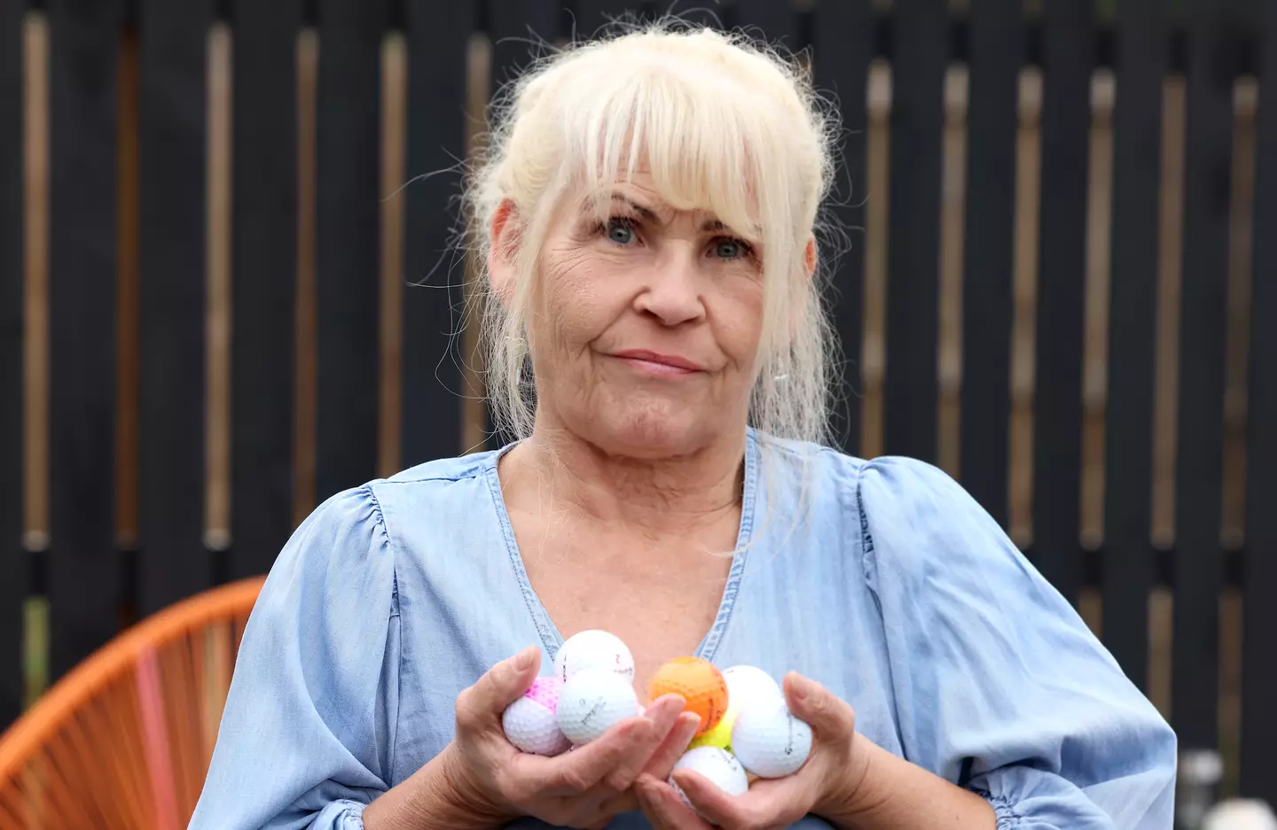 Stott shows off some of the balls she's collected from her back garden (Newcastle Chronicle)