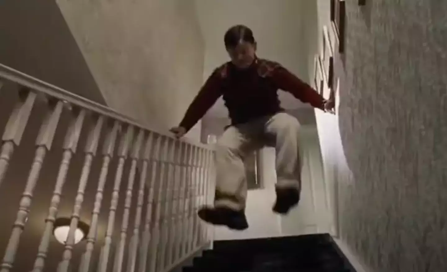 Dudley stomps and jumps on the stairs to wake Harry up.