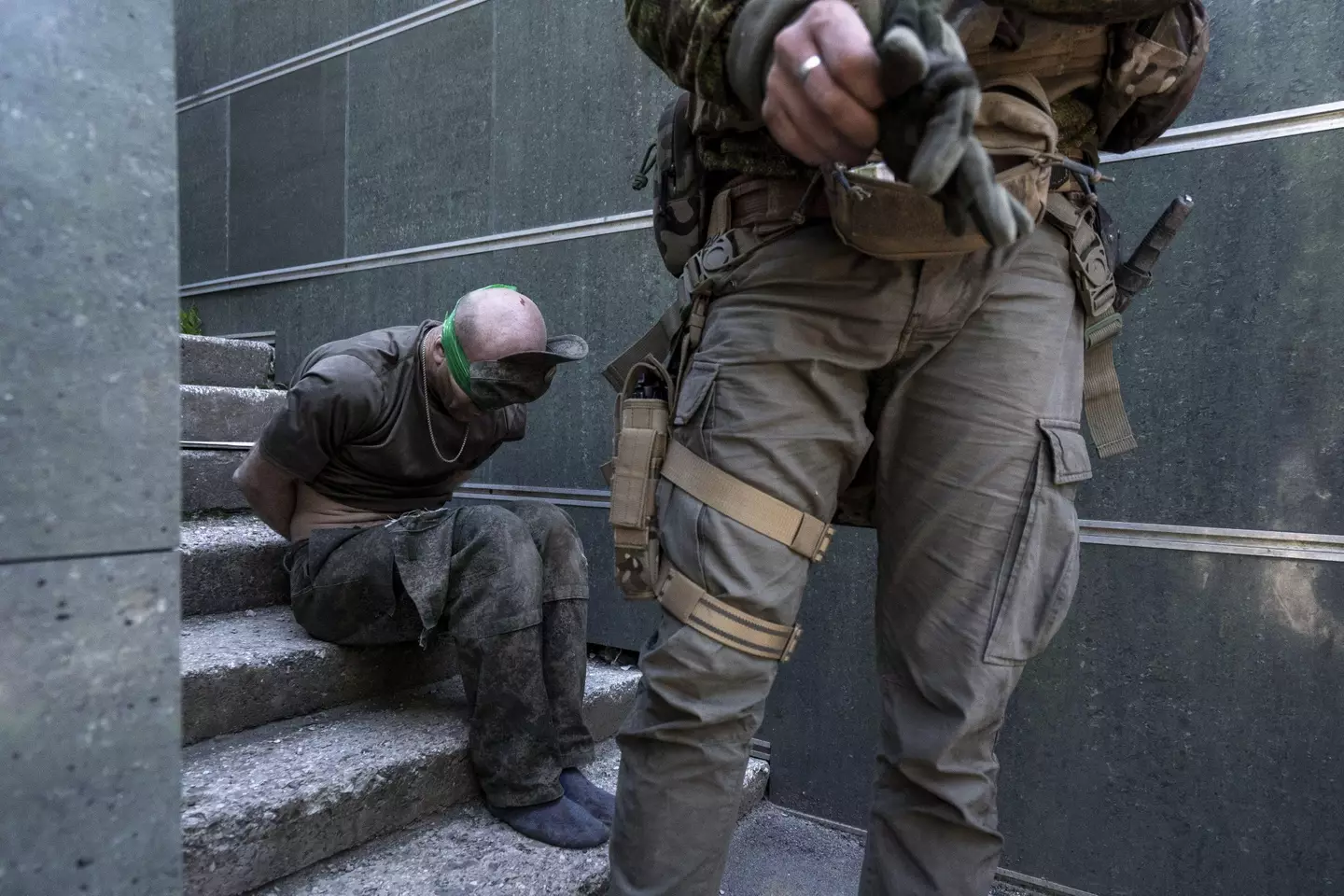 A Russian soldier being captured by Ukrainian forces.