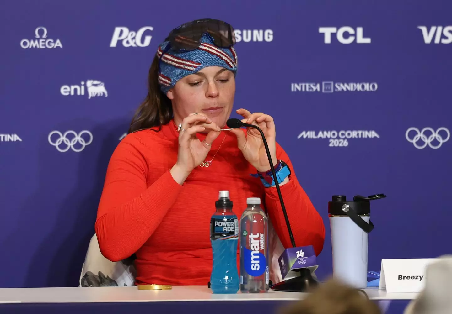 Johnson held up the parts of her medal during a press conference. (Julian Finney/Getty Images)
