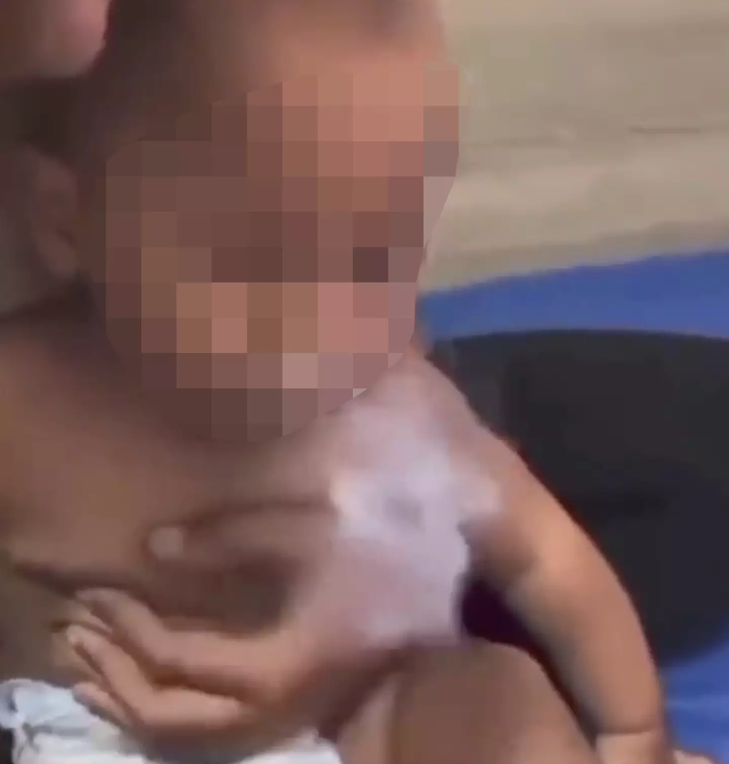 The baby can be seen coughing and spluttering after inhaling from the vape.