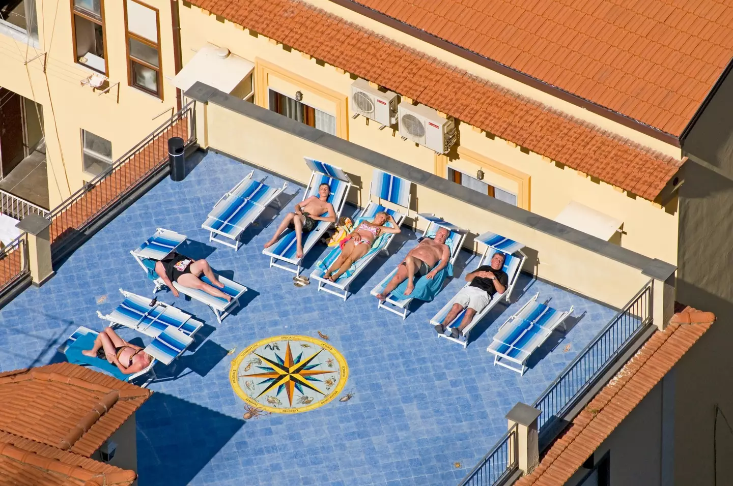 Tourists sunbathing in Sorrento.