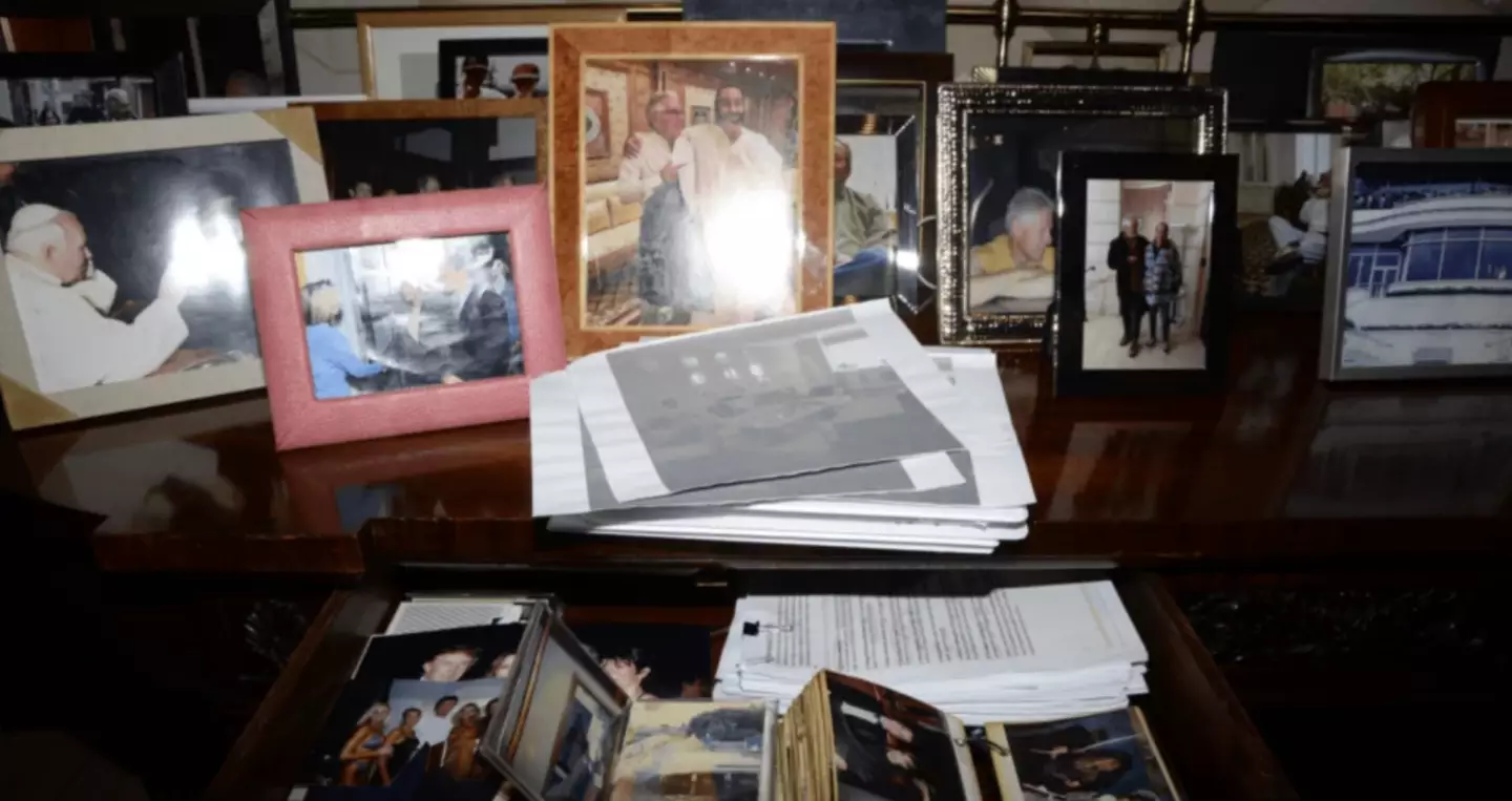 An photo of framed images, which Trump can be seen in, vanished from the website before later reappearing. (US DOJ)