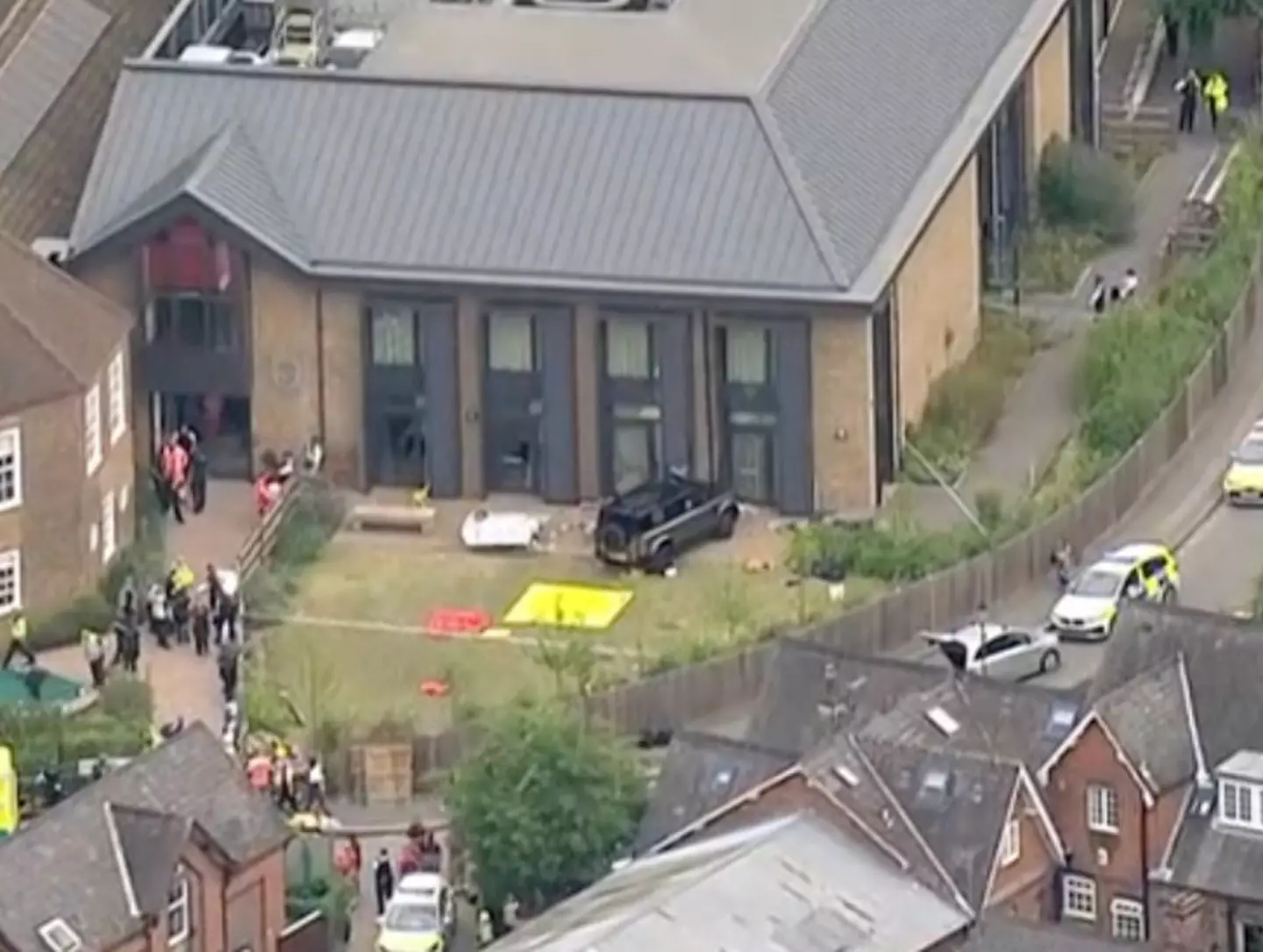 The car came to rest after colliding with the school wall.