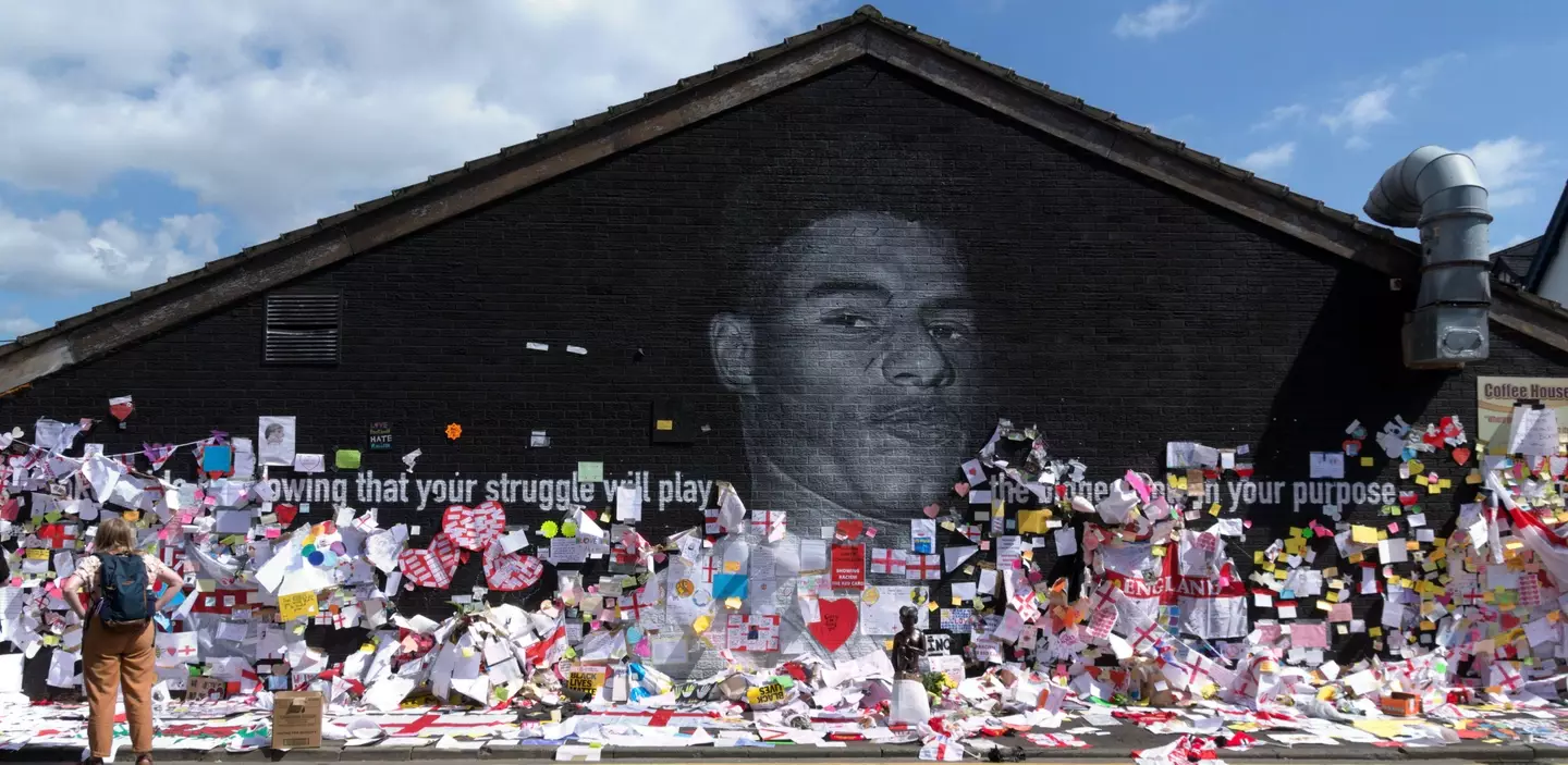 A mural of Marcus Rashford in Manchester was covered in supportive messages after it was vandalised with racist graffiti.