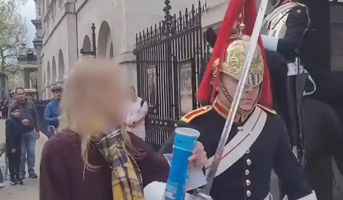 A woman said the King's Guard pushed her.