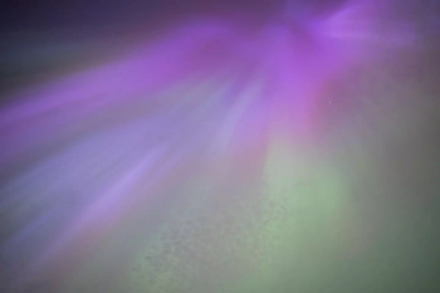 A purple green glow is what many see in the sky (Ian Forsyth/Getty Images)