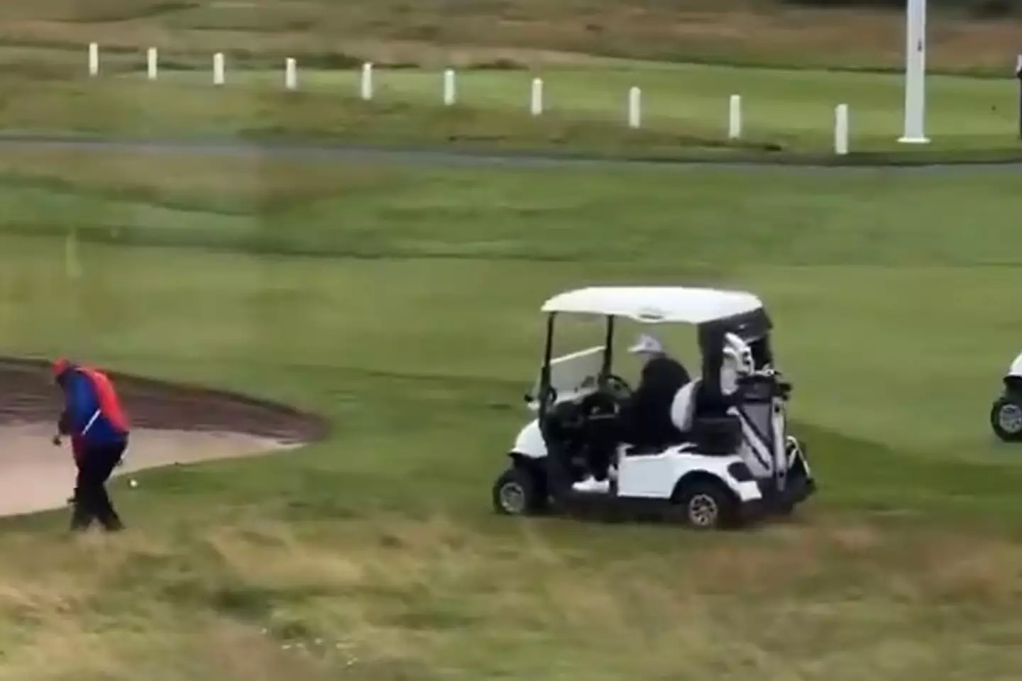 The caddy was filmed appearing to give the president a helping hand at his Turnberry golf course in Scotland (X)