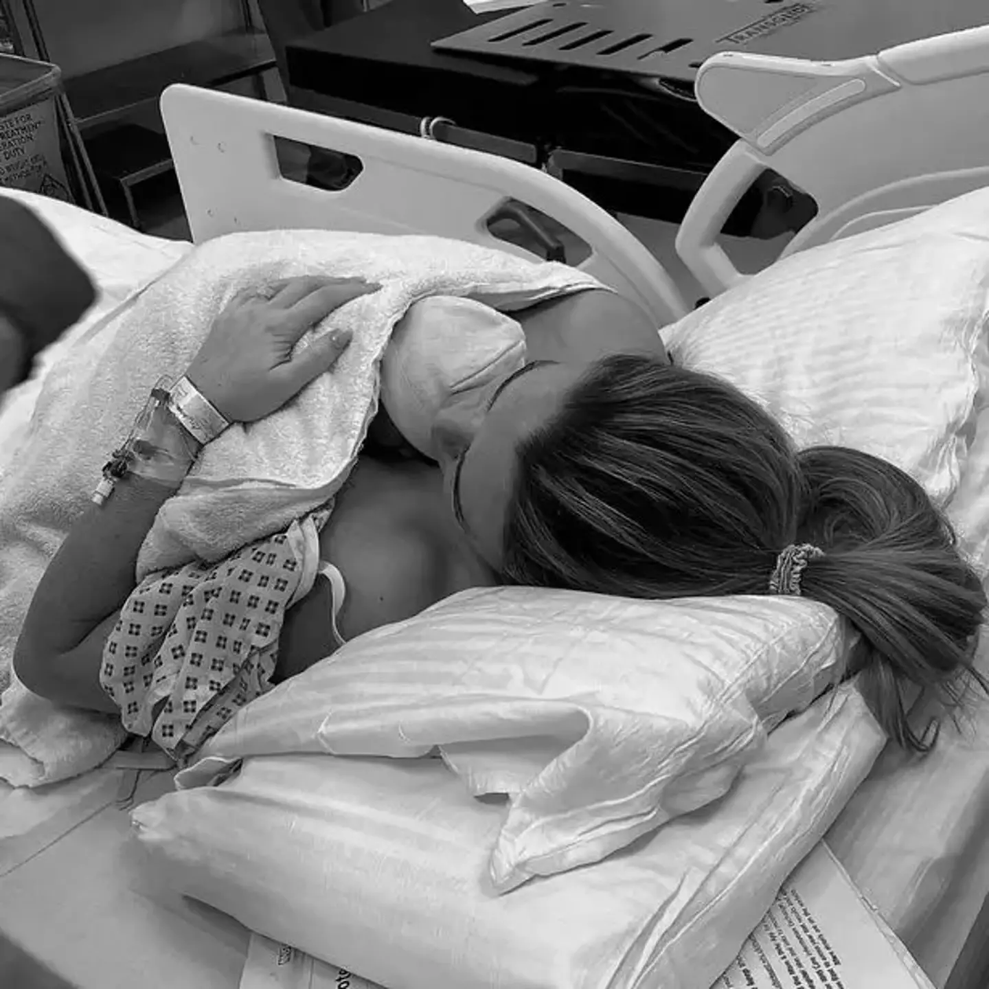 Emily and newborn daughter sharing a moment together in hospital.