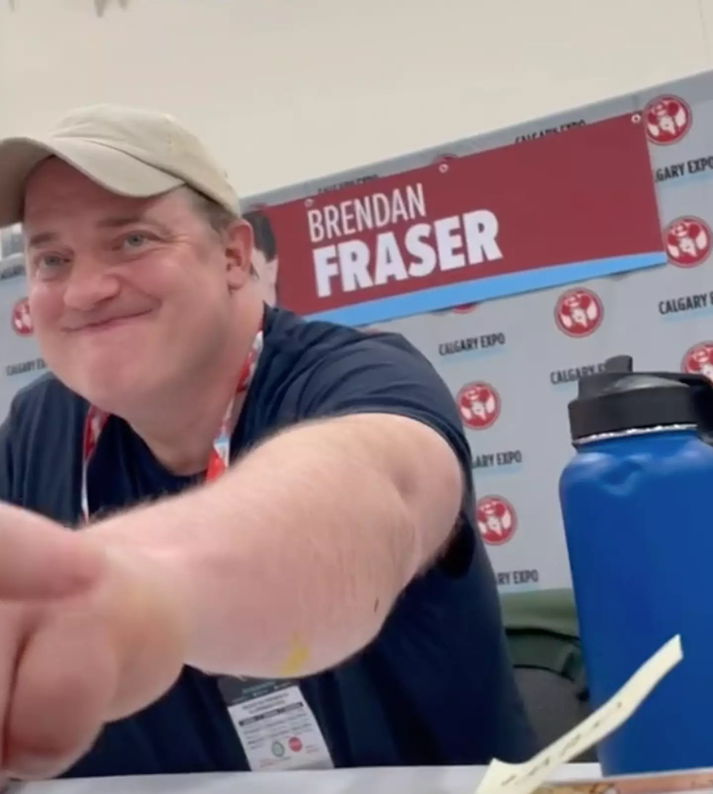 Brendan Fraser fist bumps a fan.